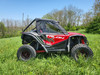 Driver side profile of the red Honda Talon 2-seater with 3 Star upper doors and rear panel in tall grass