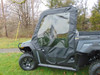 Driver side view of the 3 Star soft door and vinyl window on a gray side-by-side on a lawn