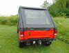 3 Star black soft bed cover with clear rear window on a red Mahindra Roxor, rear view in a grassy field