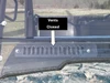 3 Star two-piece windshield with the lower vent slots closed, labeled, seen from the front over a camo hood
