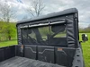 3 Star soft back panel with mesh and vinyl window installed on a camo side-by-side, seen from the bed