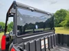 Close-up of the 3 Star tinted polycarbonate rear windshield clamped to the cage above the cargo bed