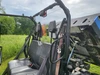 3 Star polycarbonate rear windshield mounted behind the seats of a New Holland 850 Crew with bed tilted up