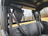 Inside view of the 3 Star rear windshield behind the seats of a Cub Cadet Challenger MX, headrests and belts in frame