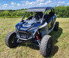 3 Star soft top on a blue and gray Polaris RZR Pro XP 4, front three-quarter view in a mowed field