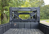 Straight rear view from the cargo bed of the 3 Star canvas back panel on the CFMoto UForce 800XL under trees