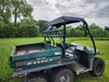 Rear three-quarter view of a green 1999 Polaris Ranger with the 3 Star canvas top over the cab and dump bed