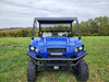 3 Star black canvas top on a blue Kawasaki Pro FXR, head-on view parked in a grassy field