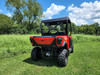Rear three-quarter view of a red Tracker Off Road 500S with the 3 Star soft top over the open cab