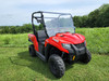 3 Star 2-piece general-purpose windshield on a red Tracker Off Road 500S, front three-quarter view on grass