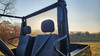 3 Star soft back panel with clear window behind the seat headrests of a Mahindra Roxor at sunset, rear view
