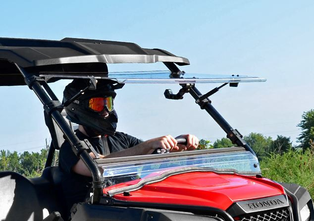 SuperATV flip out windshield tilted open on the red Honda Pioneer 500, front side view