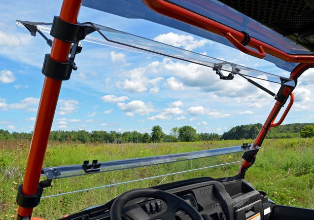 Inside view of the SuperATV flip-out windshield hinged open on the orange cage of a Kawasaki Mule Pro-FXT