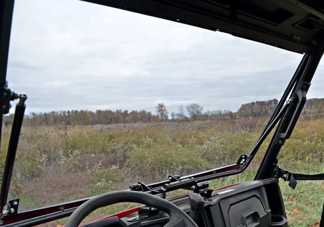 Inside view of the SuperATV flip-out windshield hinged open on the cage of a Polaris Ranger 570 Mid-Size