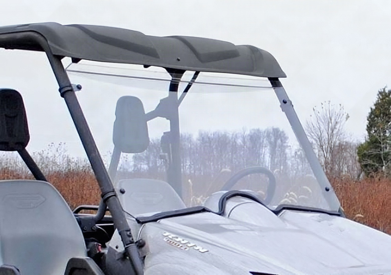 SuperATV scratch resistant full windshield installed on a silver Yamaha Rhino with roof, close front three-quarter view