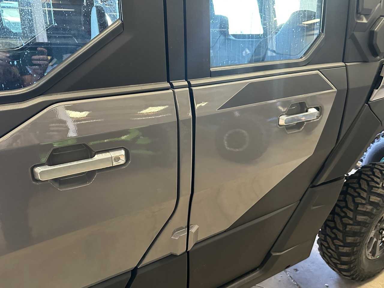 Both rear-door Dirty Teeth Racing billet handles on the passenger side of a gray Polaris Xpedition