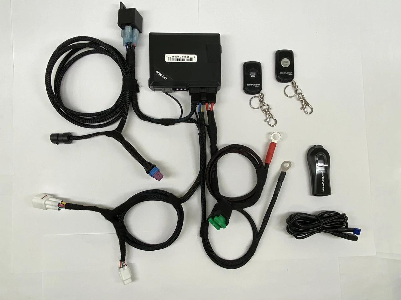 Dirty Teeth Racing remote start kit for the Kawasaki Ridge laid out: control module, wiring harnesses and two fobs