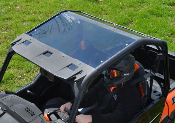 SuperATV tinted roof installed on an orange Polaris General with a driver, seen from above the cab