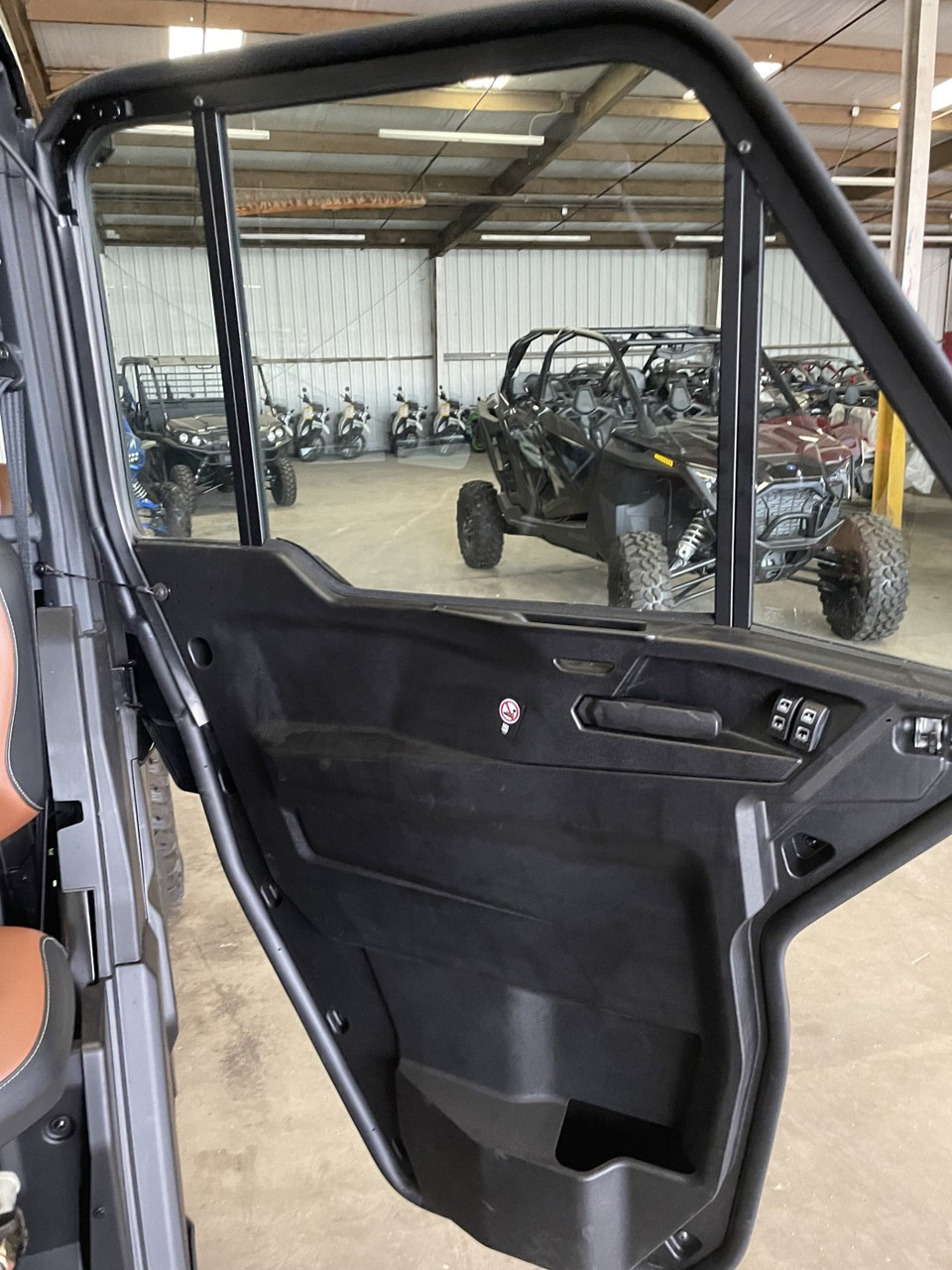 Inside view of a Can-Am Defender door with the Dirty Teeth Racing power lock actuator by the handle
