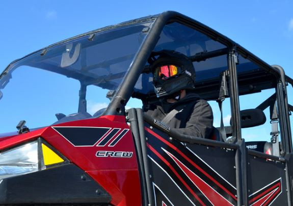 Side view of the SuperATV tinted roof over the Polaris Ranger XP 900 Crew cab with a helmeted driver