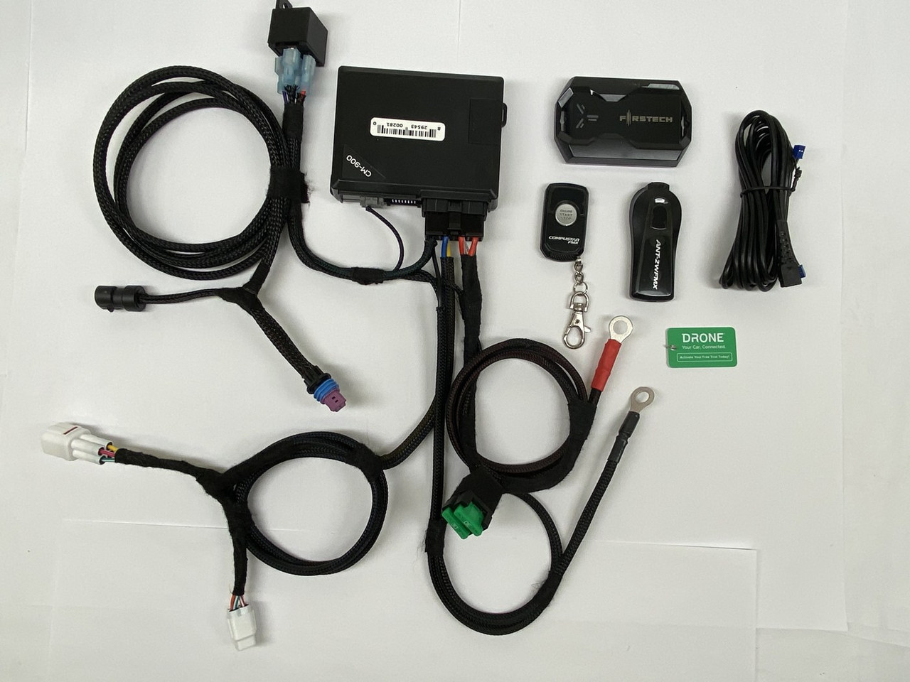 Dirty Teeth Racing Drone remote start kit for the Honda Pioneer laid out: harness, control module, antenna and remote