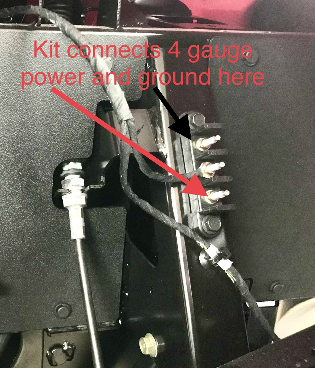 Polaris battery terminal area with arrows showing where the Dirty Teeth Racing 4 gauge power kit connects