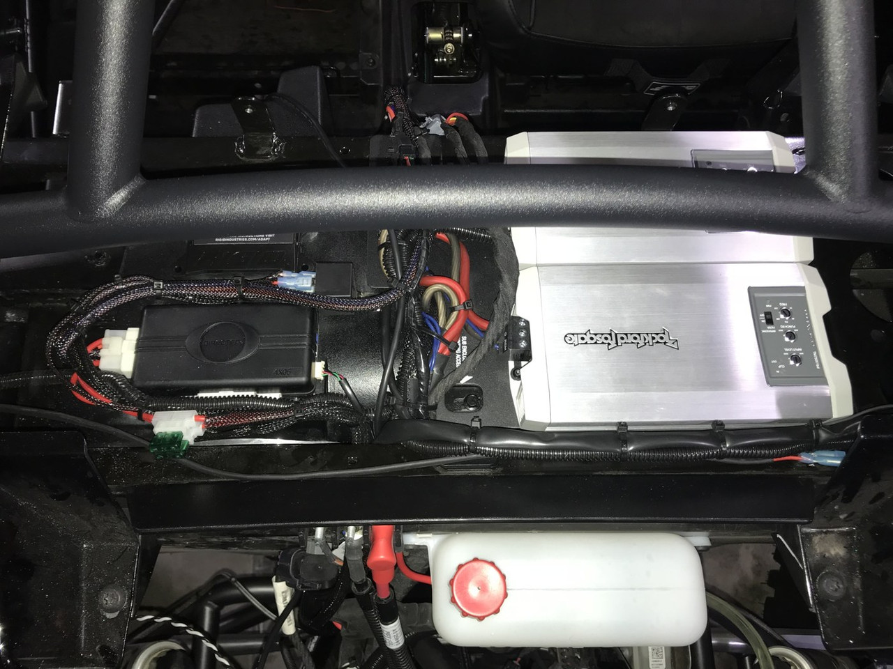 Dirty Teeth Racing remote start module mounted under the hood of a Polaris General beside the ECU and wiring