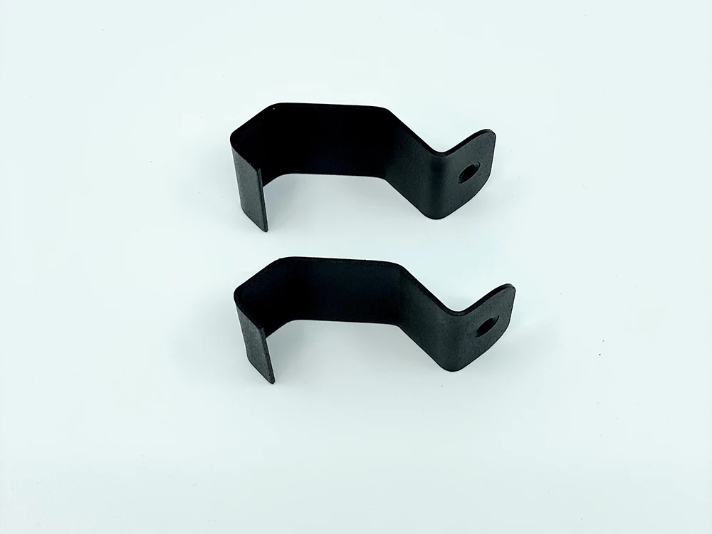 Spike replacement part for Polaris: two black metal clamp brackets on a light background