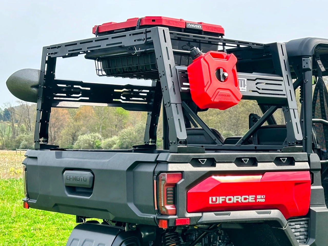 SCM bed rack for CF Moto UForce 1000 and UForce 1000 XL: bed rack with fuel can and cases on a red CFMOTO UForce