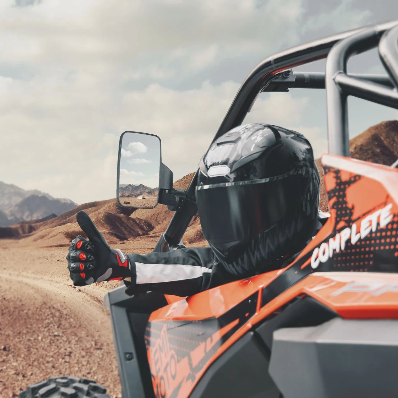 SCM mirrors for 1.75"-2.00" round roll cages: side mirror on an orange UTV roll cage, rider giving thumbs up