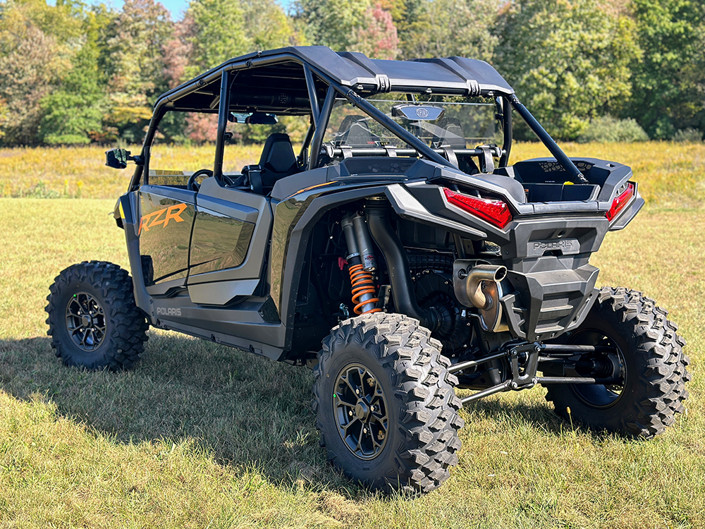 Spike rear windshield for Polaris RZR XP 1000 and XP 4 1000: rear windshield on a black Polaris RZR 4-seat in a field