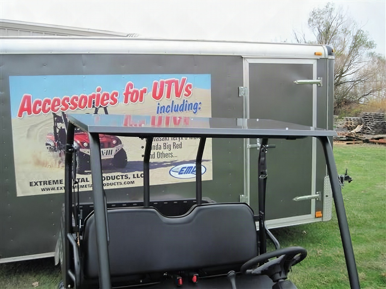 Extreme Metal Products steel roof on a Polaris Ranger mid size cage, side view in front of an enclosed trailer