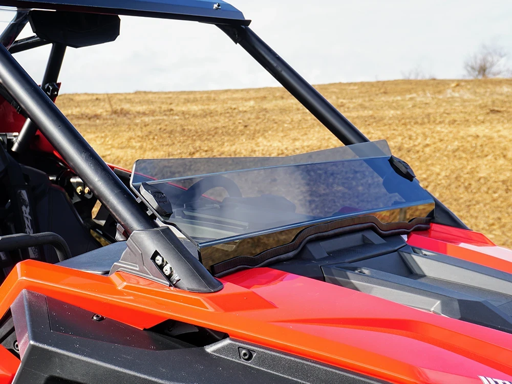 Spike short windshield for Polaris RZR Pro XP 2- and 4-seat: tinted short windshield on a red Polaris RZR Pro, side close...