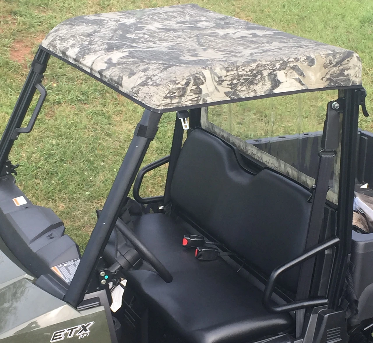 Greene Mountain Polaris Ranger roof cover in Mossy Oak camo over the bench seat