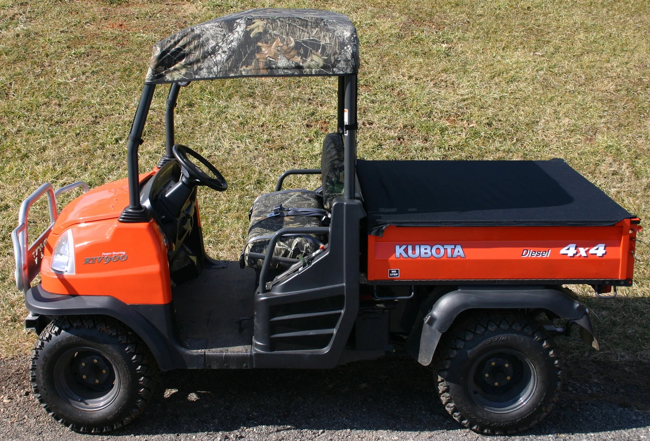 Greene Mountain Kubota roof cover in Mossy Oak camo on an orange Kubota RTV, side view