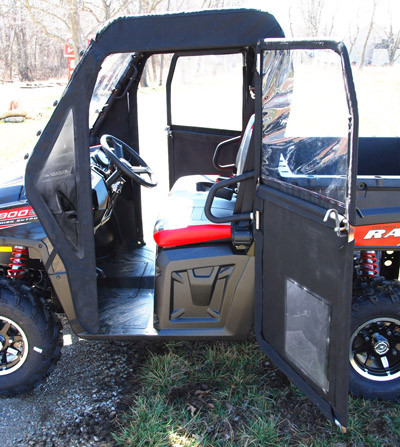 Seizmik framed door swung open on the red Polaris Ranger showing the tube frame and cab interior, side view