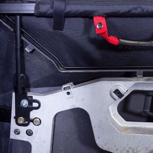 Inside view of the Seizmik upper door hinge post, red pull strap and mounting bracket on a Polaris General