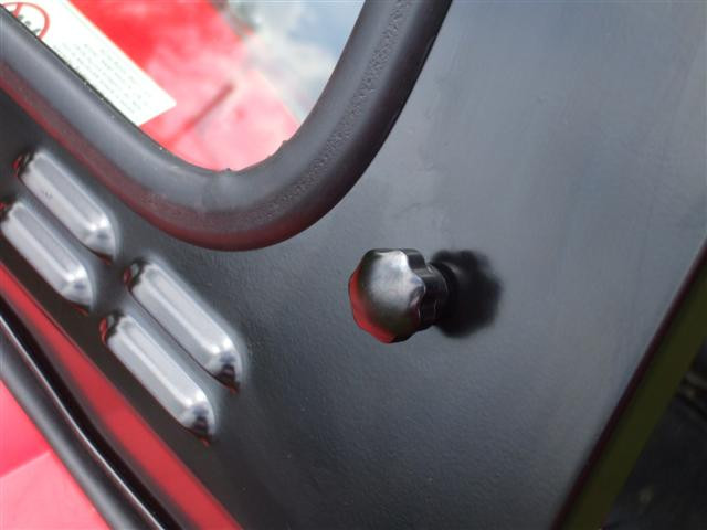 Close-up of the Extreme Metal Products glass windshield frame, vent slots and mounting knob on the RZR