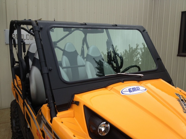 Extreme Metal Products glass windshield installed on a yellow Kawasaki Teryx, front three-quarter view