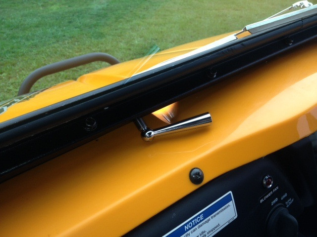 Close-up of the chrome manual wiper handle on the Extreme Metal Products glass windshield above the Teryx dash