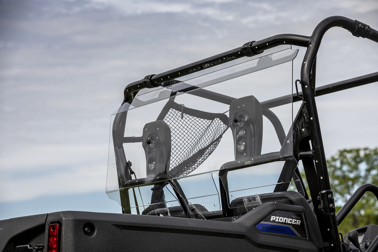 Kolpin clear rear window on a Honda Pioneer 700 roll cage, rear three-quarter view with seat net