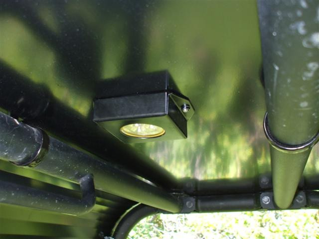 Underside of the Extreme Metal Products aluminum top on the Kawasaki Teryx showing the built-in dome light and cage clamps
