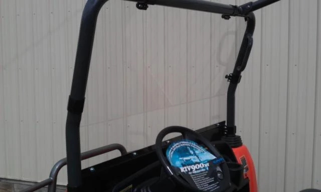 Side angle of the Lexan windshield on the Kubota RTV900 cab frame with the steering wheel visible through it