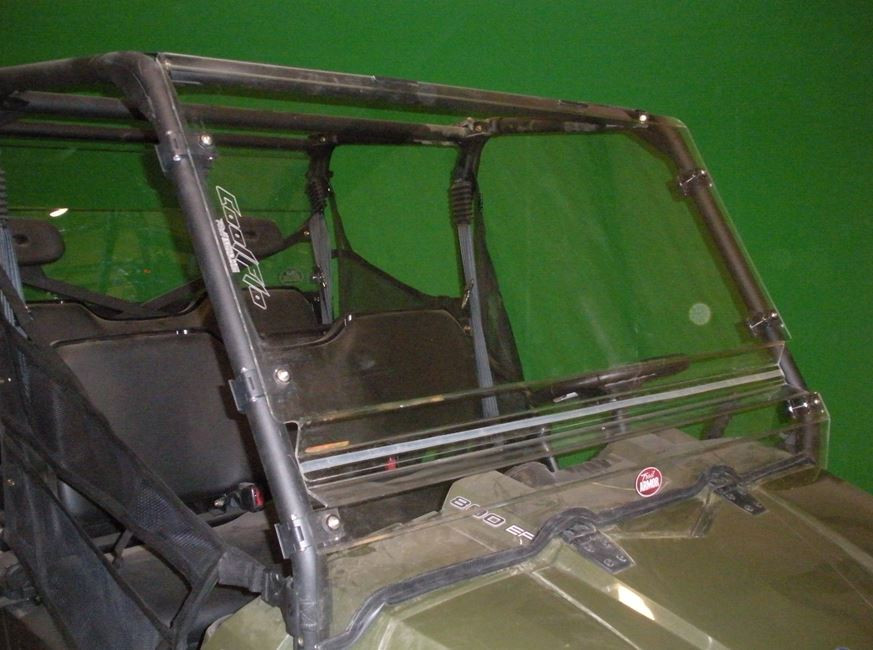 Trail Armor Cool Flo windshield installed on a Polaris Ranger in a showroom, front view against a green wall