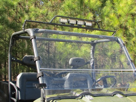 Side view of the Seizmik universal LED light bar bolted to the cage above the windshield of a green side-by-side