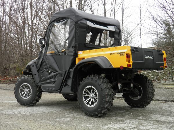 Rear three-quarter view from the driver side of the black 3 Star soft cab on the yellow Cub Cadet Challenger