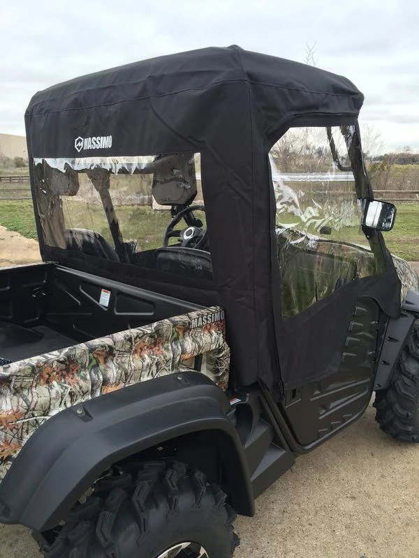 Rear view of the Side X Side cab enclosure showing the rear window panel above the cargo bed of a camo Massimo UTV