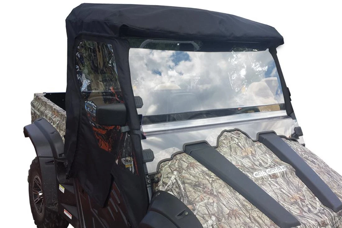 Front view of the Side X Side over-roof enclosure showing the clear vinyl windshield and roof on a camo side-by-side