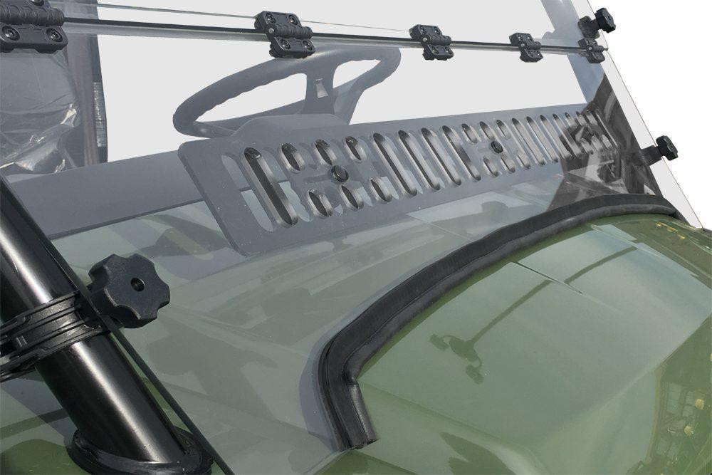 Close-up of the lower vent louver and cage clamp knob on the Spike Powersports windshield over the green Gator hood