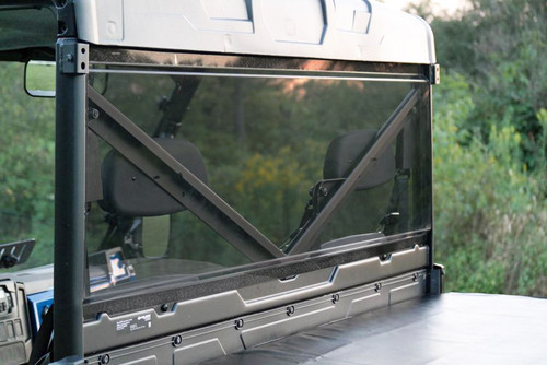 Rear view of the Spike Powersports tinted window from the Ranger bed outdoors, showing the cage bar through the tint